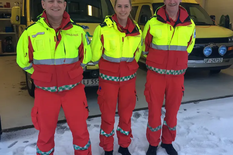 Tre ambulansearbeidere som står foran en ambulansebil. F.v. Torbjørn Kopland Mikkalsen, Maria Vik og Bjørn Bakken