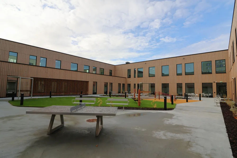 Table tennis and a bench in front of a building